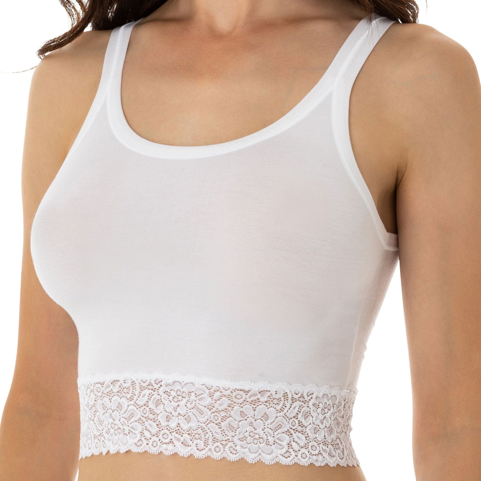 Dark-haired woman wearing a white narrow shoulder crop top with lace details from Tramonte.